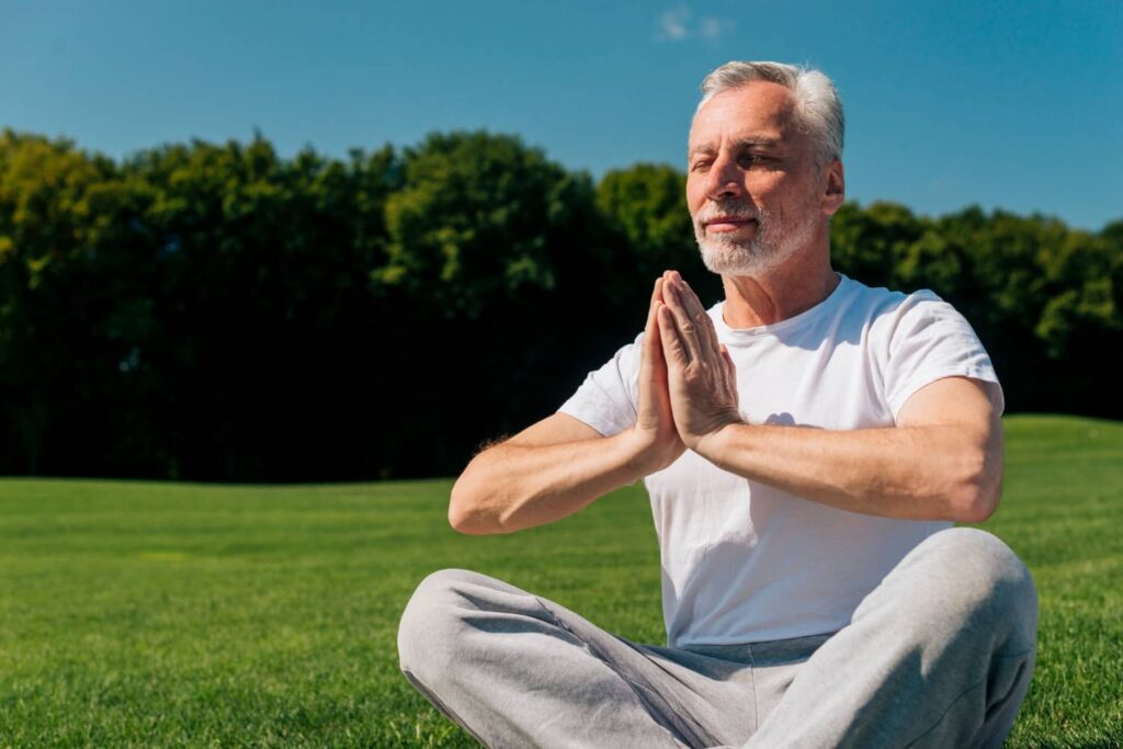 Guy over 60 doing yoga